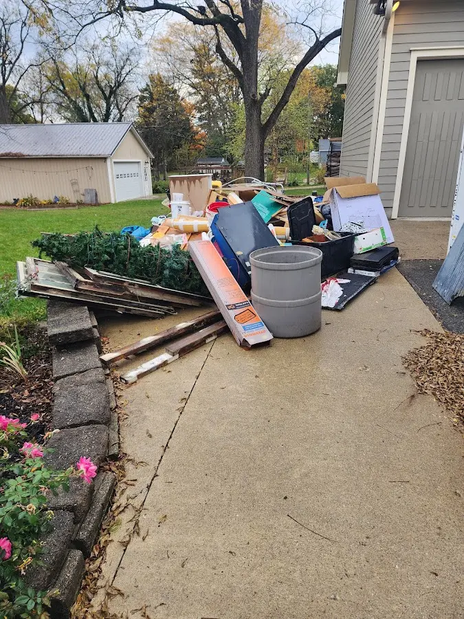 Dumpster being loaded with debris for 12 Yard Dumpster Rental in Fishers